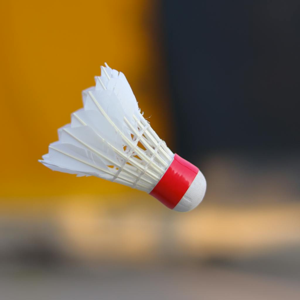 Close-Up Photo of a White and Red Shuttlecock